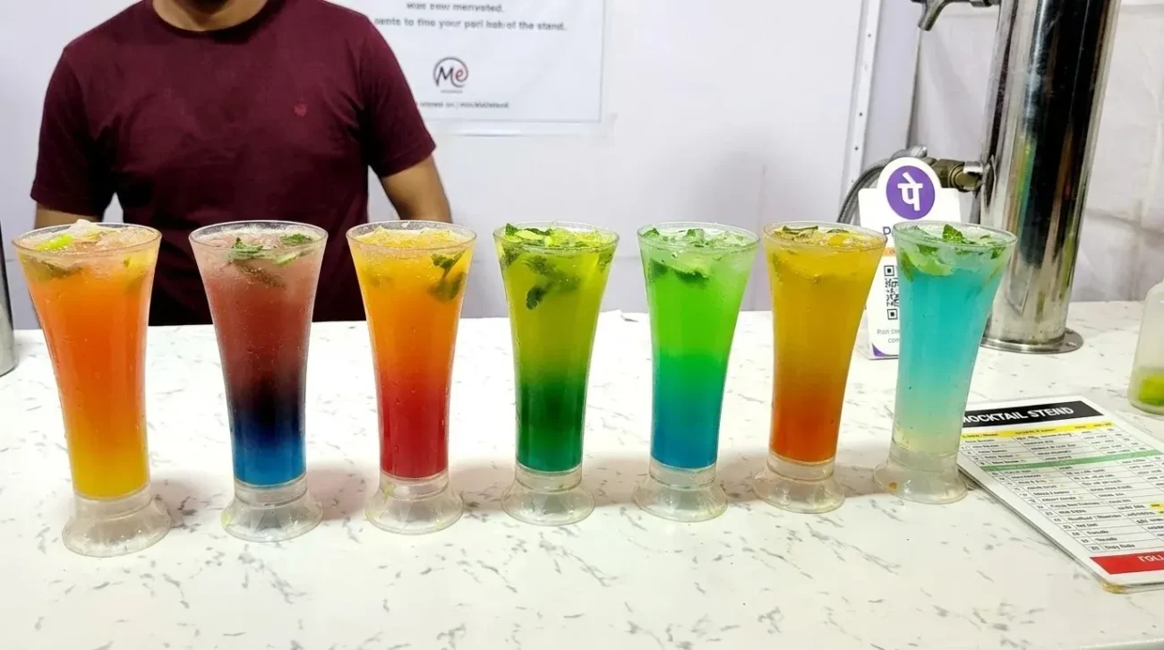 Colorful layered mocktails n tall glass from the Mocktail Stend menu photographed